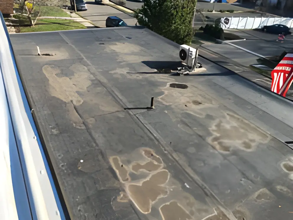 Flat rooftop with air conditioning unit.