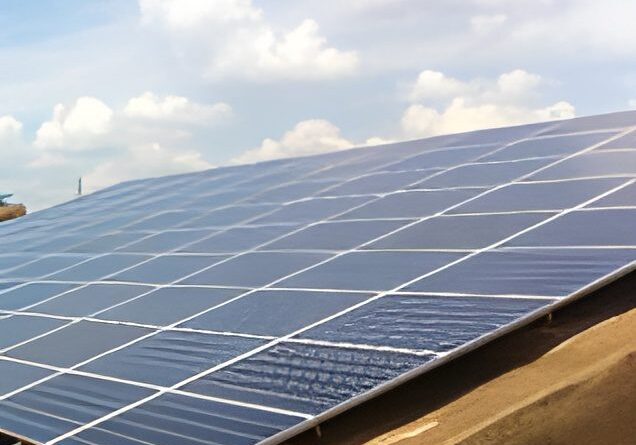 Solar panels on a rooftop under clouds.