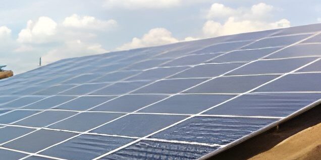 Solar panels on a rooftop under clouds.