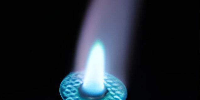 Blue flame from a lighter in darkness.