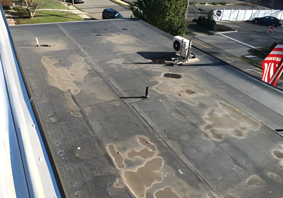 Flat rooftop with air conditioning unit.